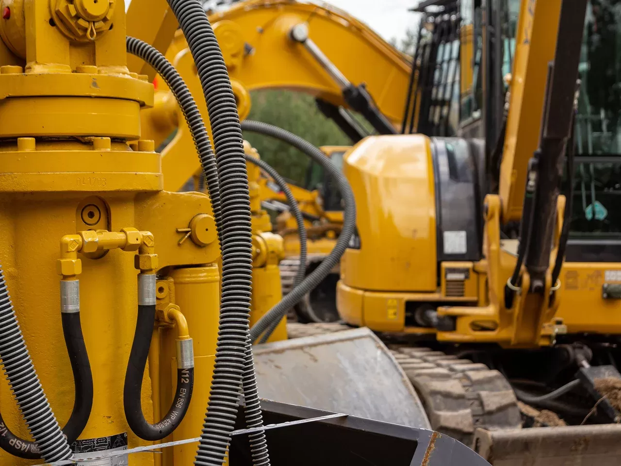 Close-up of hydraulic system and hoses on heavy construction equipment in industrial setting